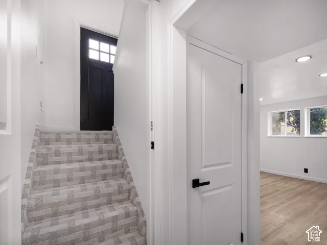Patterned carpeted staircase with white risers