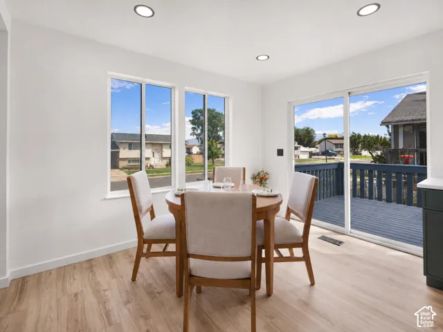 Wood-finish flooring, recessed lighting, and white painted walls