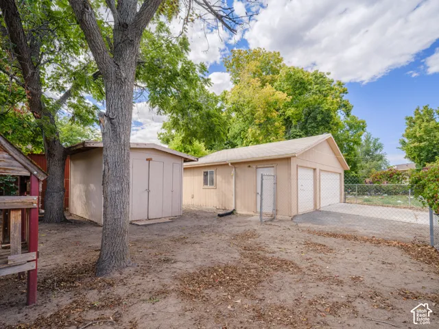 Detached three-car garage with asphalt driveway
