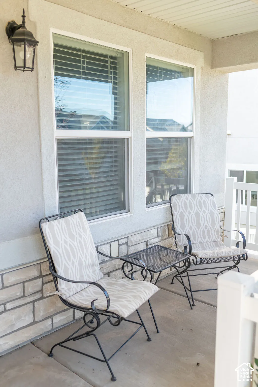 Covered porch with concrete flooring and stone veneer detailing