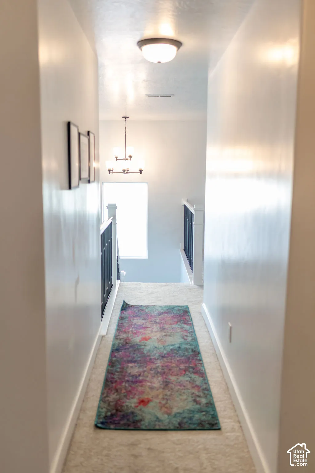 Hallway with carpet flooring and white walls