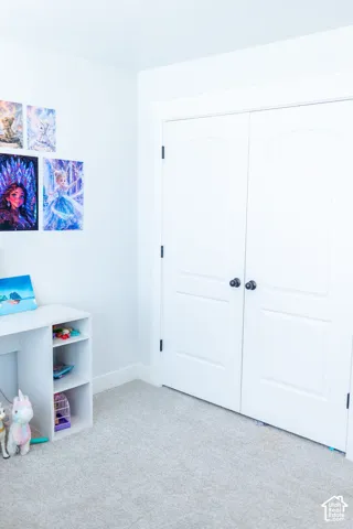White arched panel closet doors with black hardware