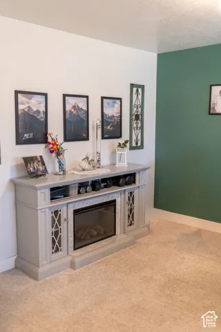 Electric fireplace with a light gray mantel, integrated cabinetry, and an inset firebox