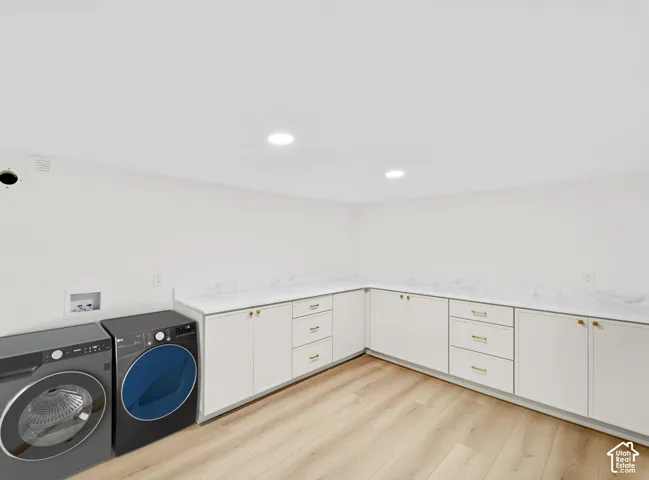 Light wood-finish flooring, white cabinetry, white countertops, recessed lighting, and a white ceiling