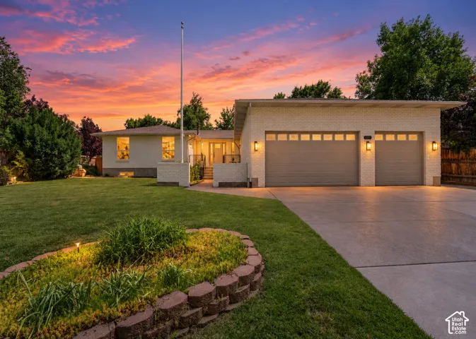 Light brick exterior with a two-car garage featuring panel windows