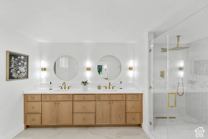 Dual vanity with a white countertop and wood-finish cabinetry