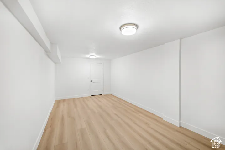 Recessed ceiling lights illuminate this space with wood-finish flooring