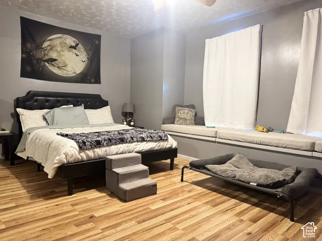 Hardwood-finish flooring, built-in window seating, and a ceiling fan