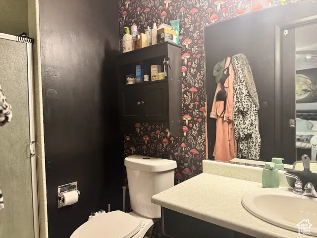 Vanity with integrated sink, black cabinet with silver hardware, and wall-mounted black medicine cabinet