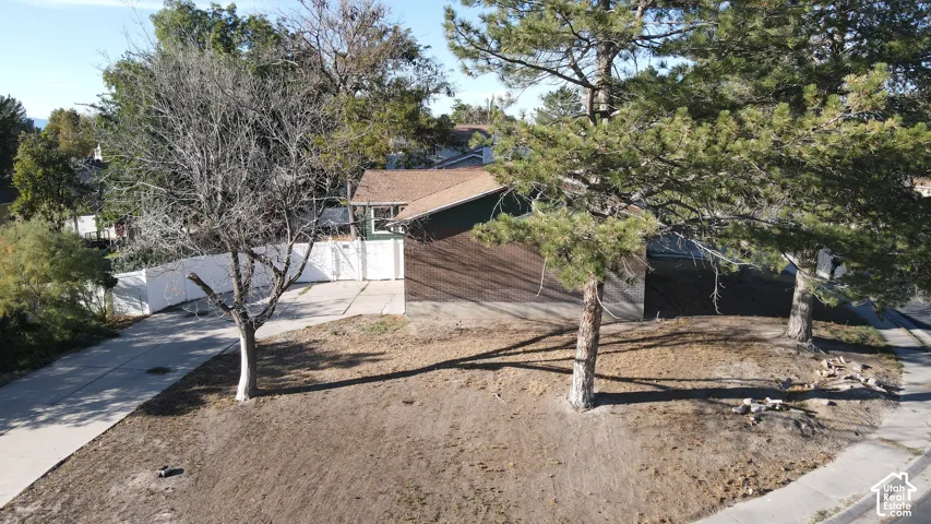 Gable roof structure with a dark shingle roof and green siding