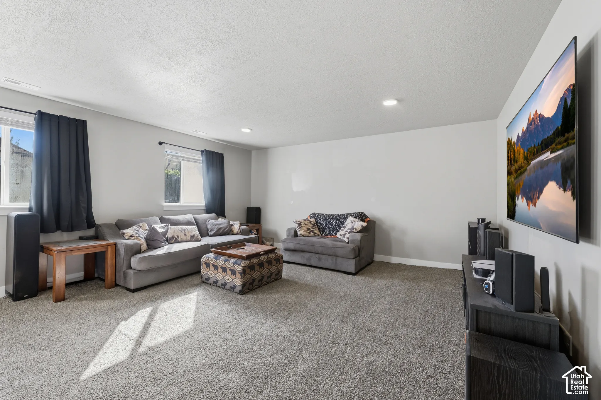 Neutral-toned interior featuring wall-to-wall carpeting, recessed lighting, and dual windows