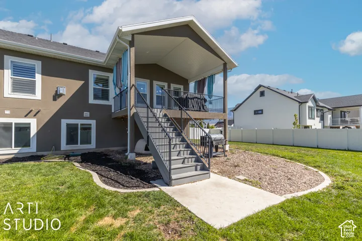 Covered elevated deck with black railings and stairs