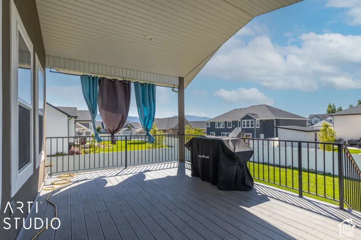 Covered deck with composite decking and black metal railings