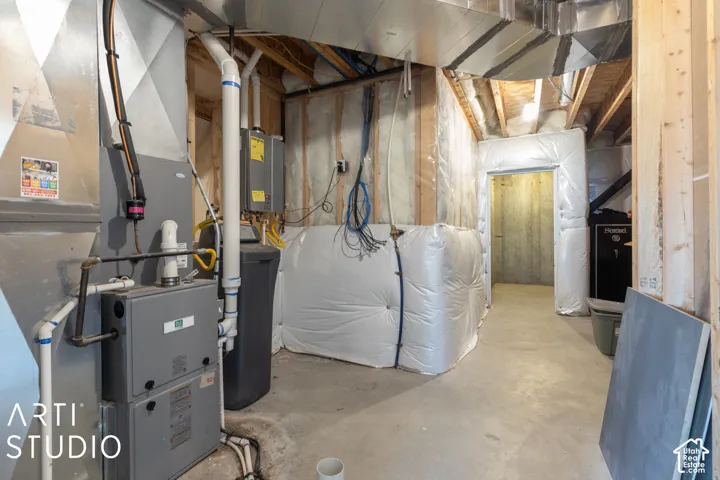 Basement utility area with exposed wood framing, concrete flooring, and visible ductwork