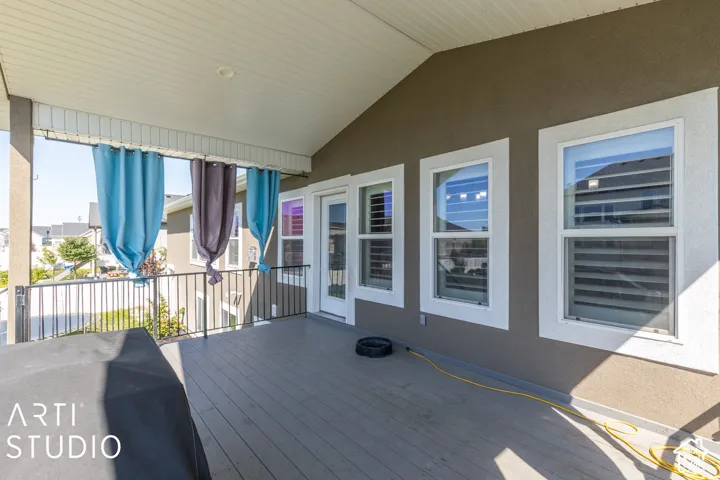 Covered outdoor patio with composite decking and black metal railings