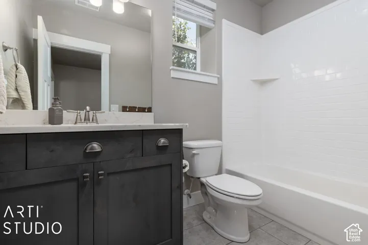 Dark wood-finish vanity with drawer pulls, integrated sink, and white countertop