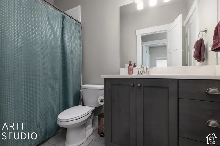 Contemporary bathroom featuring a dark wood-finish vanity with dual drawers and chrome hardware, white quartz countertop, and polished chrome faucet