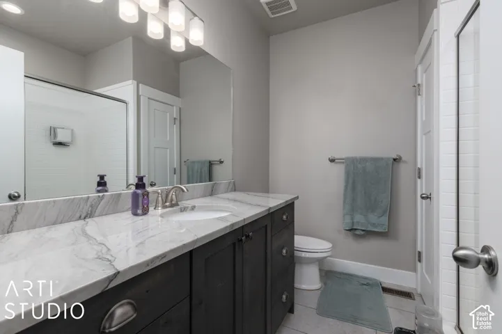 Modern vanity with a light-toned countertop, integrated sink, and dark wood-finish cabinetry