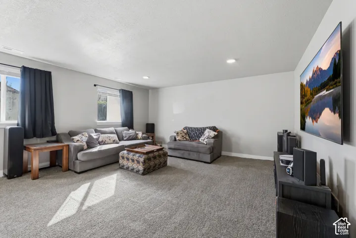 Neutral-toned interior featuring wall-to-wall carpeting, recessed lighting, and dual windows
