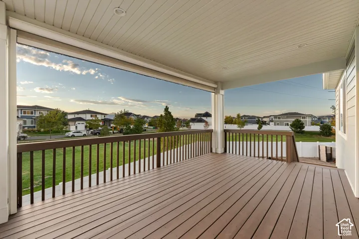 Covered composite deck with recessed lighting and a wood-finish railing