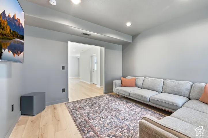 Recessed lighting, light wood-finish flooring, and a wide entryway