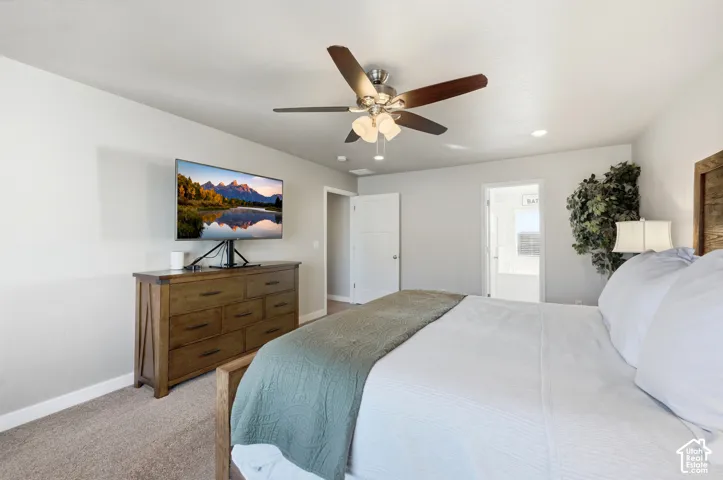 Recessed lighting, ceiling fan with light fixture, light gray wall tones, and carpet flooring