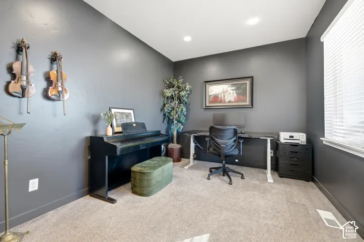 Recessed lighting, window with blinds, and carpeting