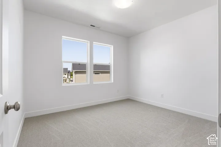 Neutral carpet flooring and white walls