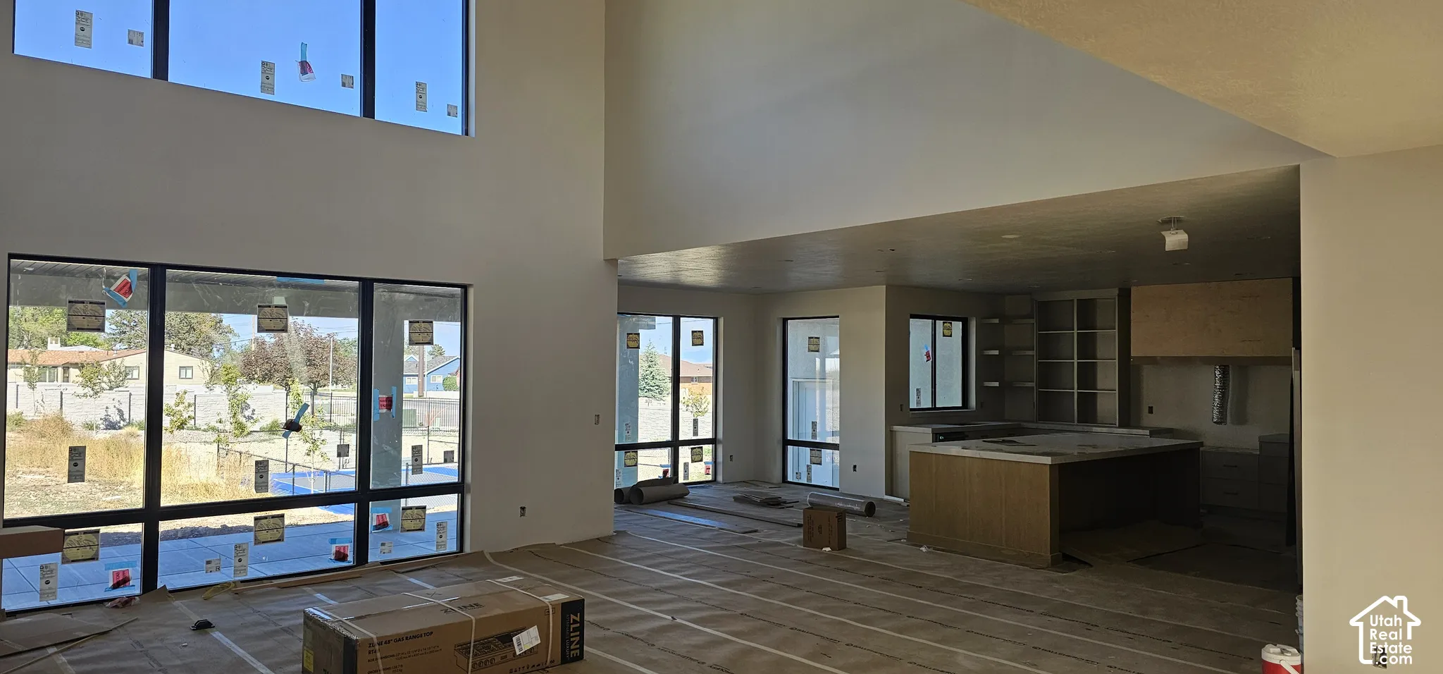 Expansive open-concept space featuring soaring ceilings and large-format windows