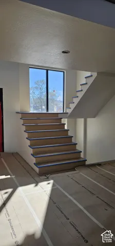 Floating staircase design with wood-finish treads and risers