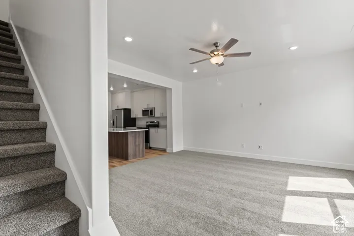 Carpeted flooring, recessed lighting, and a ceiling fan