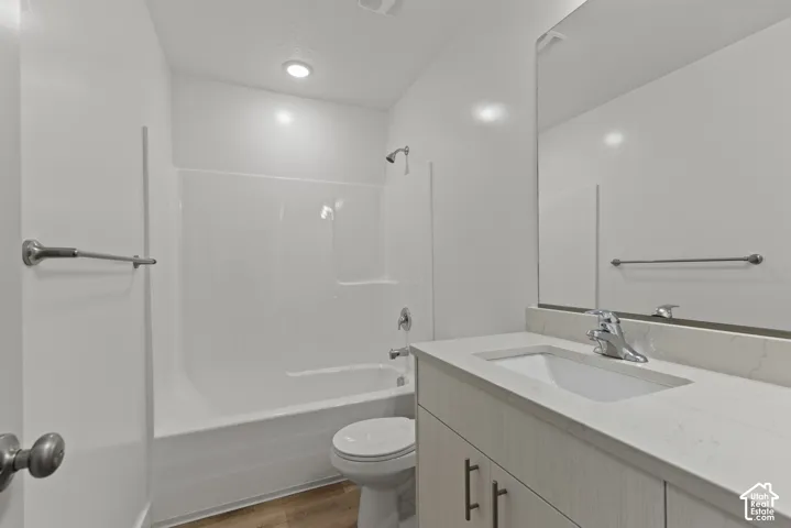 White vanity with a light-toned countertop and an integrated sink