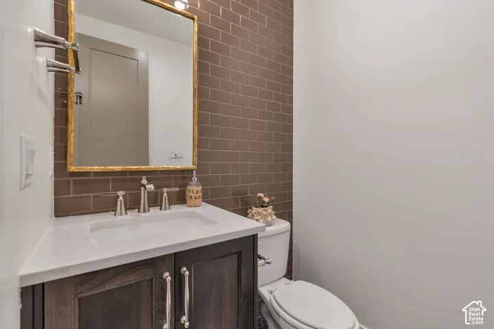 Integrated vanity with built-in sink, dark wood-finish cabinetry, and brushed nickel fixtures