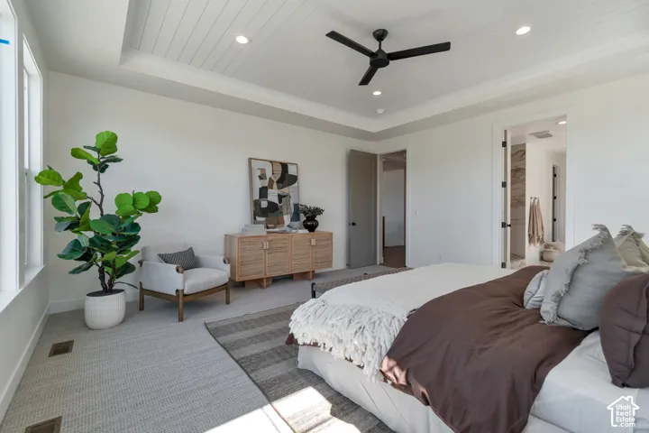 Tray ceiling with shiplap accent, recessed lighting, and a matte black ceiling fan