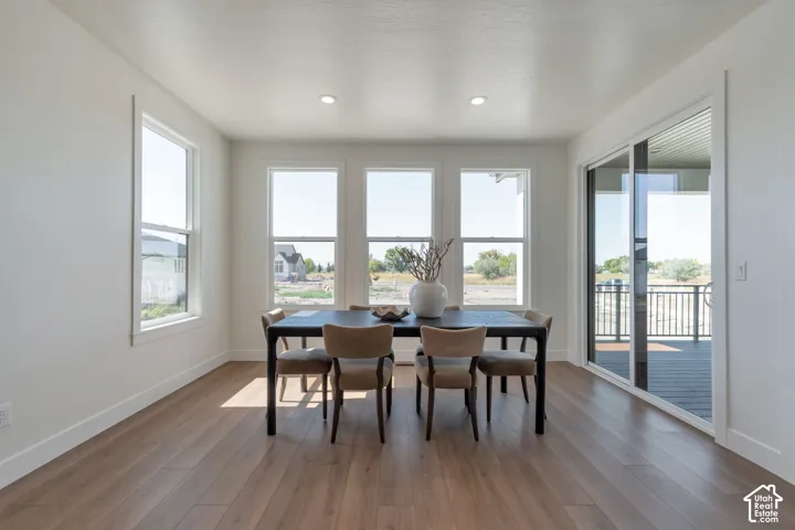 Wood-finish flooring, recessed lighting, and multiple windows