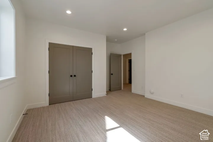 Recessed lighting illuminates the room, featuring a neutral color palette
