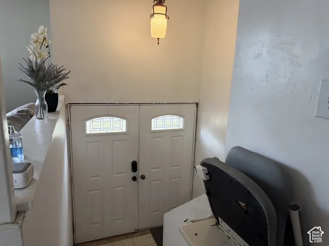 Dual entry doors featuring arched leaded glass panels