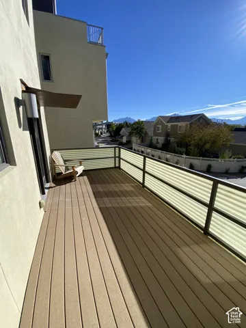 Expansive outdoor deck with composite decking, modern railing system, and exterior wall sconce