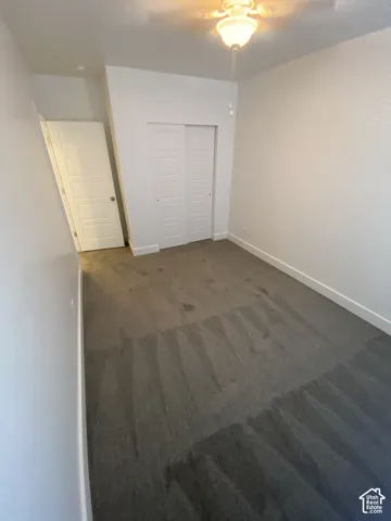 Recessed lighting, ceiling fan with integrated light fixture, neutral carpeting, and white trim