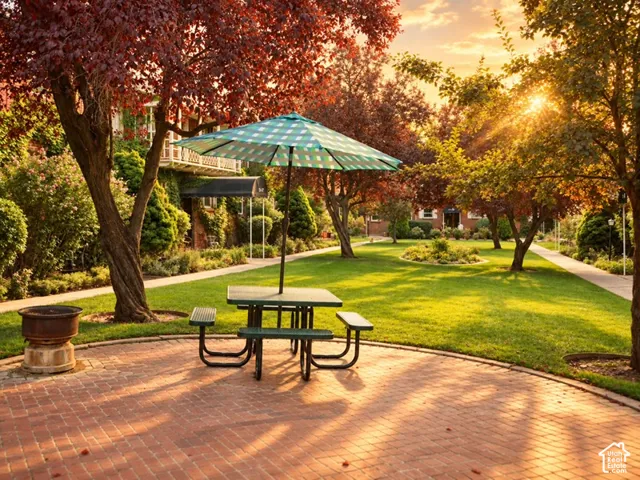 Expansive lawn with mature trees, a red brick patio, and a paved walkway