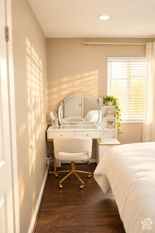Recessed ceiling lighting illuminates the room with wood-finish flooring and a window featuring blinds