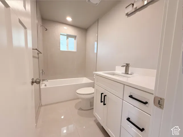 White vanity with black pulls, undermount sink, and chrome faucet