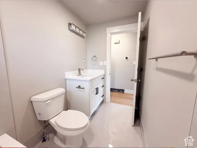 White vanity with chrome hardware, an integrated sink, and brushed nickel faucet