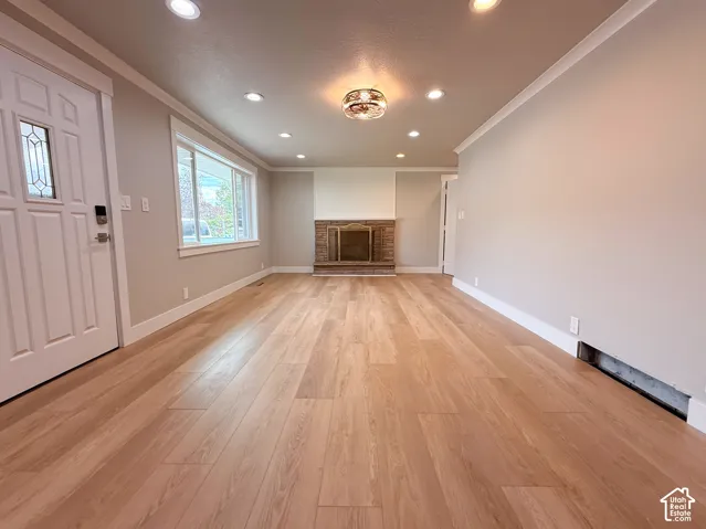 Recessed lighting, wood-finish flooring, and a brick fireplace