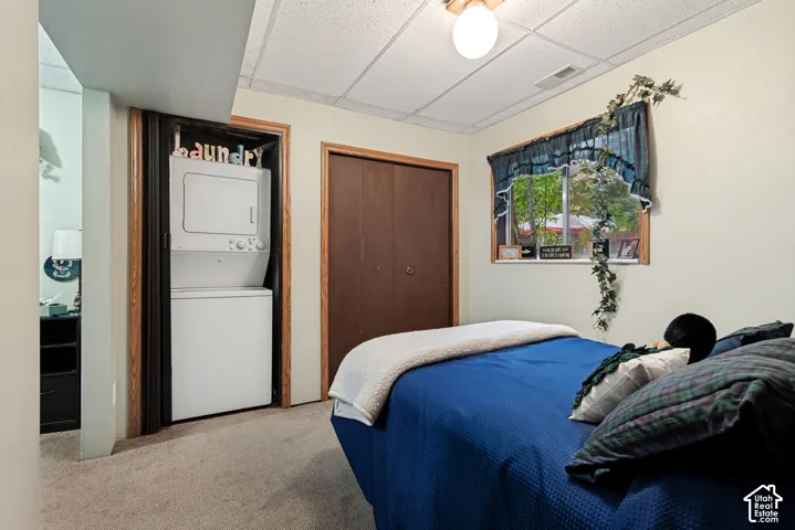 Basement Bedroom 1 with closet and stackable washer/dryer.