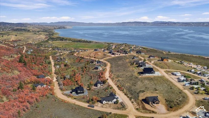 Expansive rural landscape with a prominent large lake and distant mountains