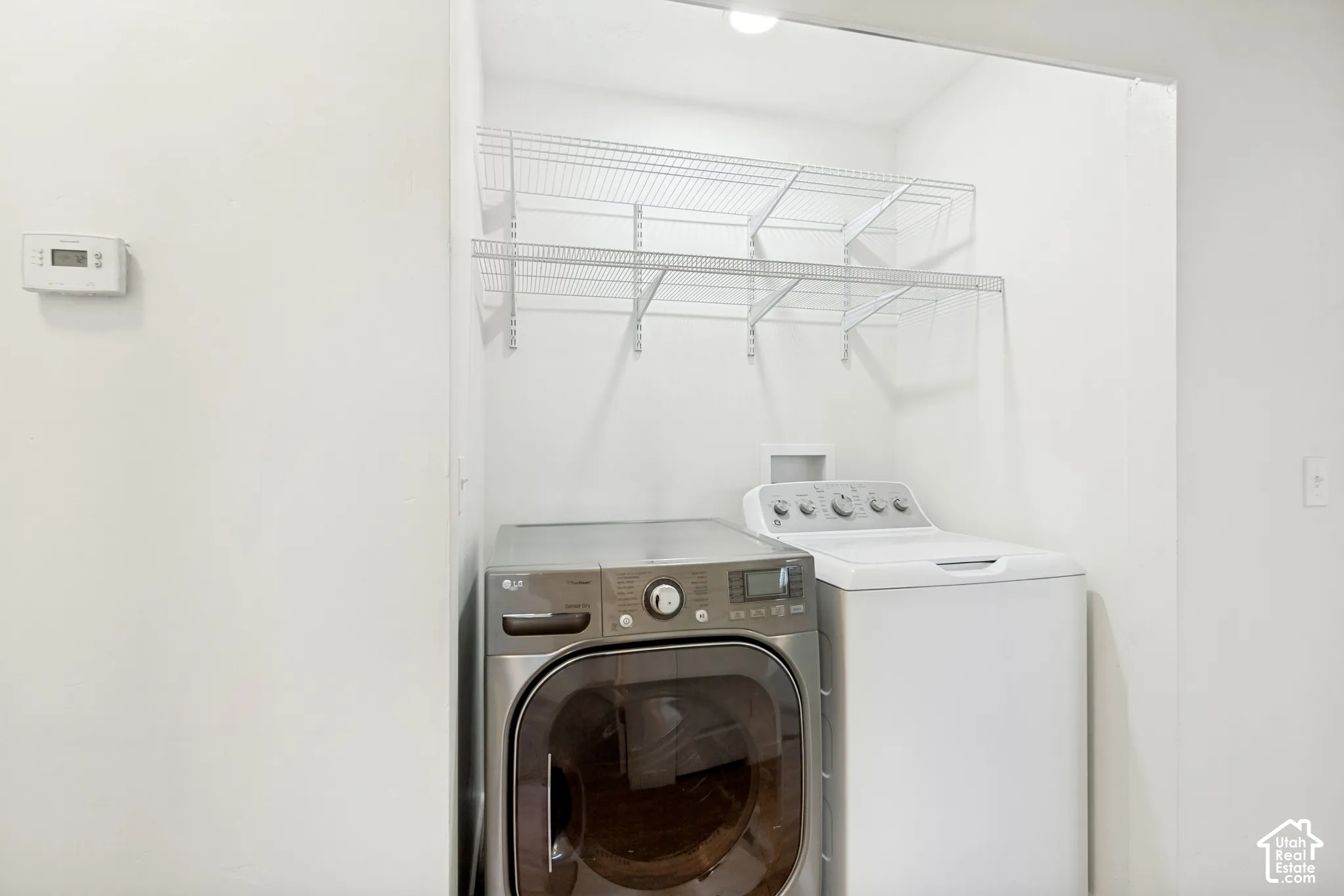 White washer and dryer units with wire shelving