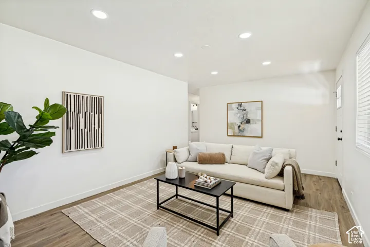 Recessed ceiling lighting, durable wood-finish flooring, and white painted walls