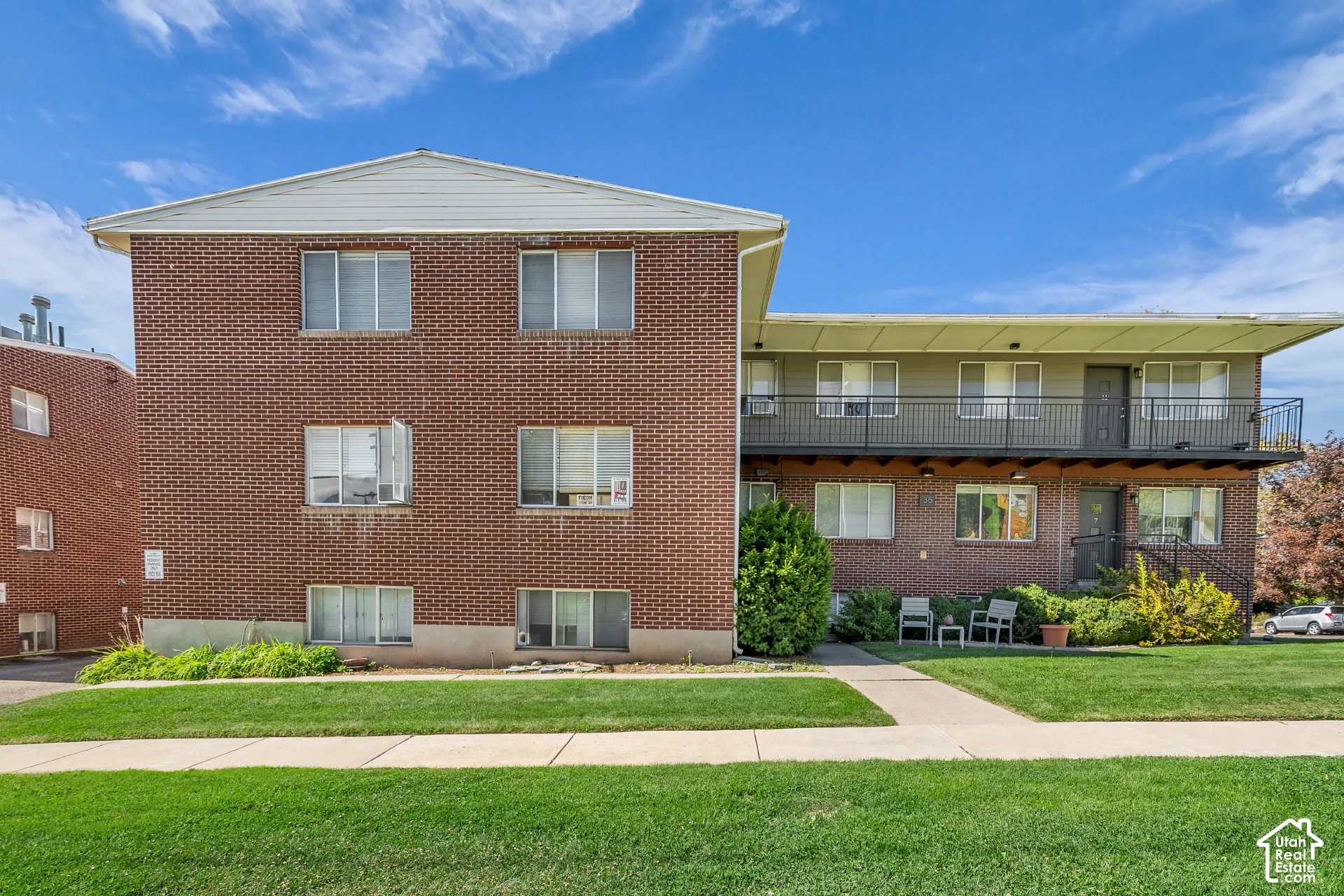 Brick exterior construction featuring multiple windows and a flat roofline