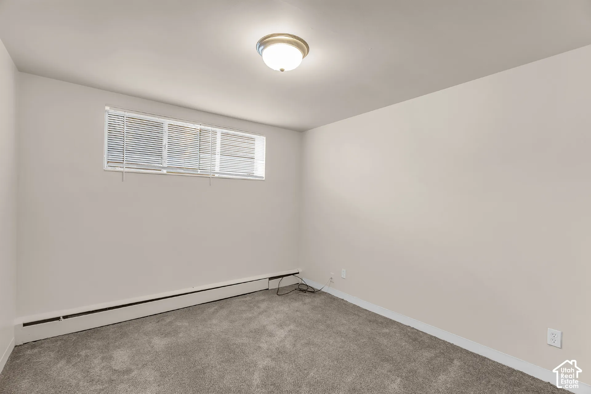Neutral-toned walls complement the gray carpeting